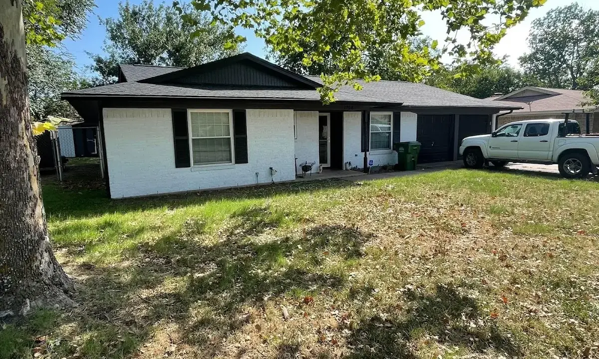 Professional roofing crew working on a residential roof in Huntsville